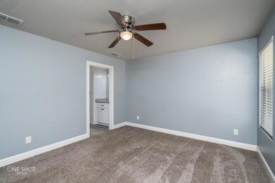 Spare room with carpet and ceiling fan