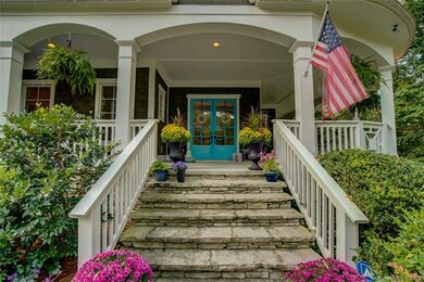 Wide stone steps to arch topped porch