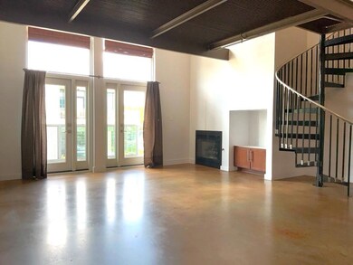 Unfurnished living room with finished concrete fl