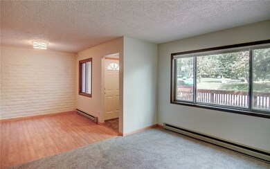 Living and dining room with a baseboard heating un