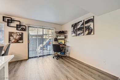 Office space featuring wood finished floors and ba