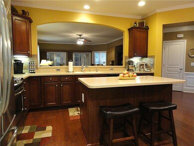 Custom arched design wall between kitchen and living room.