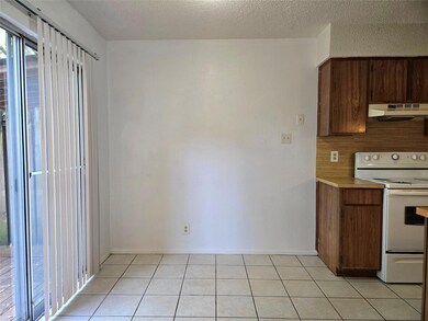 Kitchen with light countertops, baseboards, under