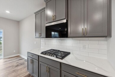Tiled backsplash and white quartz counters included!