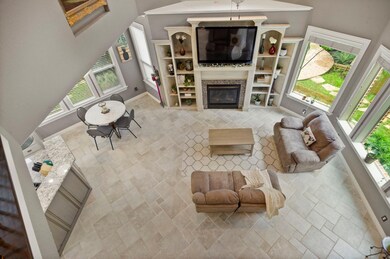 Living room with a towering ceiling and built in shelves