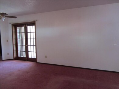 Two sets of french doors leading out to the covered patio and screened pool.