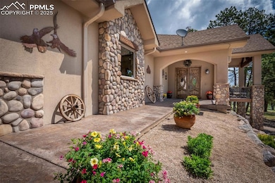 Front door entrance featuring stone and stucco siding, and covered porch