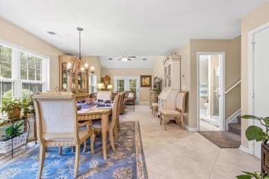 Tiled dining room featuring chandelier and a healt