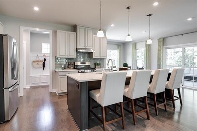 Large island in your open kitchen. Appointed with granite countertops and stainless steel appliances with option to upgrade to quartz countertops!