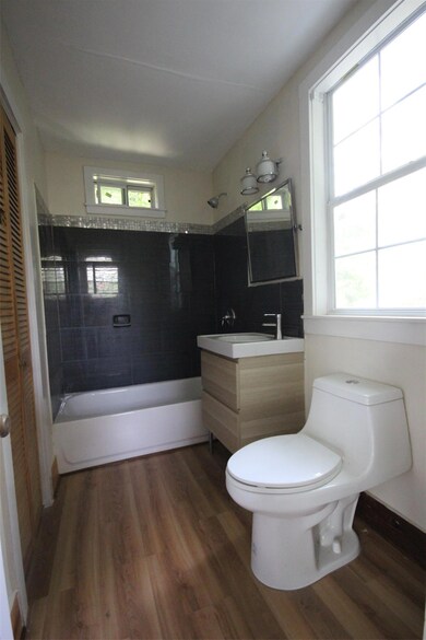 Bathroom featuring wood finished floors, toilet, 