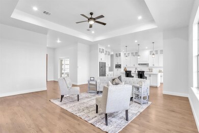Living area featuring baseboards, light wood-type 