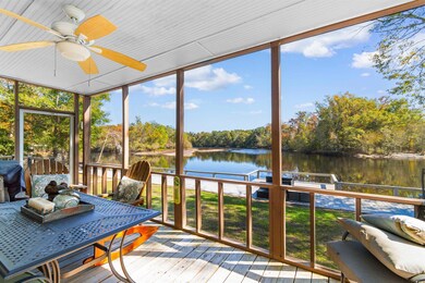 Sunroom featuring a water view and ceiling fan