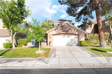 View of front facade featuring driveway, a tile ro