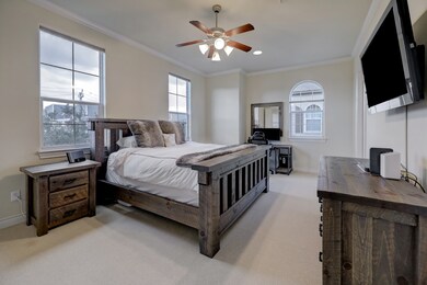 Spacious third floor primary suite has carpet, cro