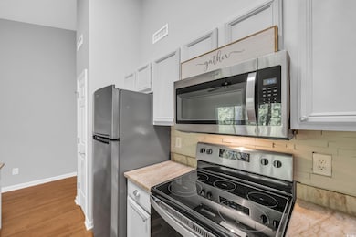 Kitchen with stainless steel appliances, tasteful 