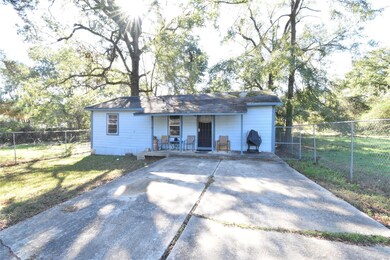 View of outbuilding with a porch and a lawn