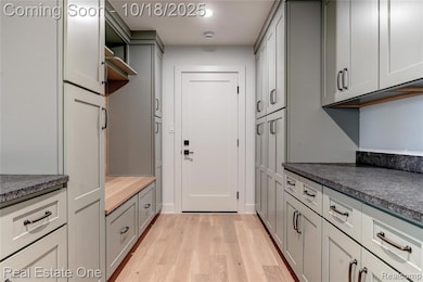 Mudroom featuring light wood finished floors and recessed lighting