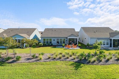 Rear view of property with a lawn and a patio