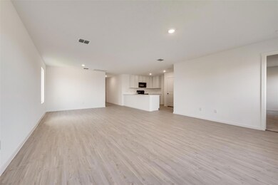 Unfurnished living room featuring light hardwood /