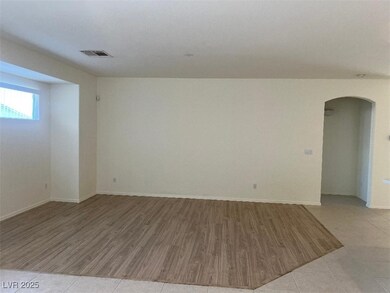 Living  area featuring arched walkways, light wood