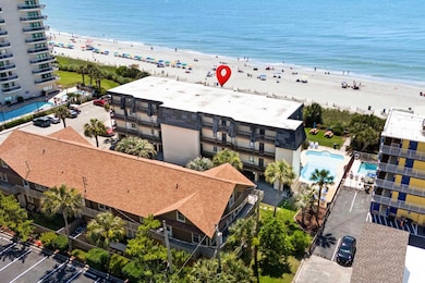 Drone / aerial view of expansive beach and a pool