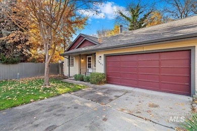 View of front of home featuring roof with shingles, concrete driveway, a garage, and covered porch
