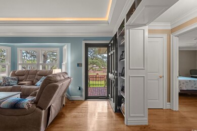 Entrance foyer with light wood-style floors and crown molding