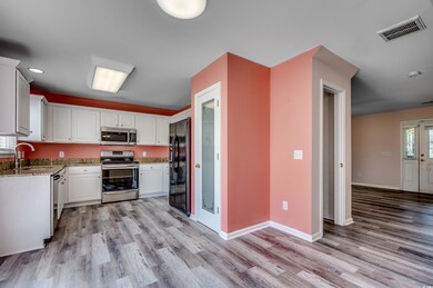 Kitchen with white cabinets, stainless steel appli