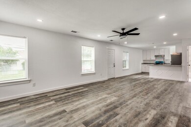Unfurnished living room with ceiling fan and wood-