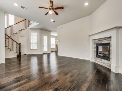 Unfurnished living room featuring ceiling fan, dar
