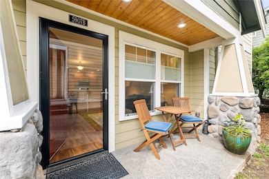 Quiet front porch abutting grass area.