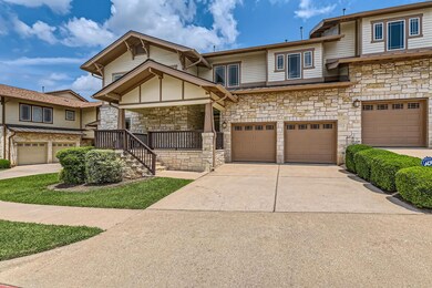 View of property featuring concrete driveway, an 