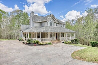 Country-style home featuring a front yard, concret