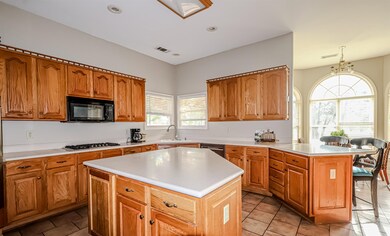 Kitchen featuring light countertops, a sink, black