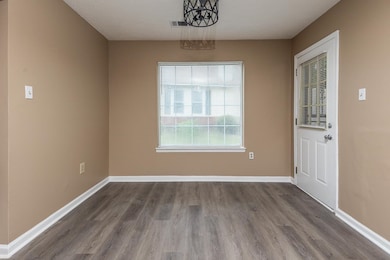 Unfurnished room with a textured ceiling and hardwood / wood-style flooring