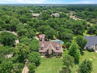 Aerial view featuring a forest view