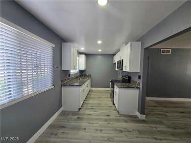 Kitchen featuring light wood-style floors, applian