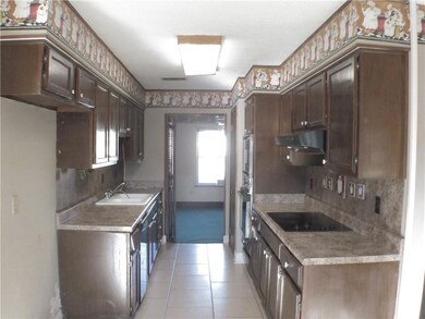 View of galley-style kitchen, with glass cook top,
