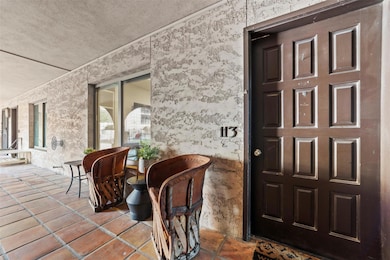Doorway to property featuring a patio and stucco 