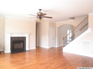 The great room has HW floors, a gas log firplace, canned lighting, and looks out over the open deck to the hot tub.