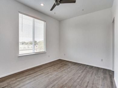 Empty room featuring ceiling fan and hardwood / wo