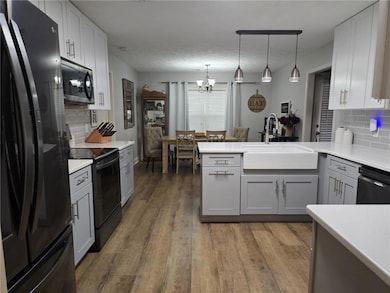 Kitchen featuring black appliances, a sink, a chan
