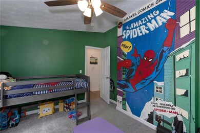 Carpeted bedroom with baseboards and ceiling fan
