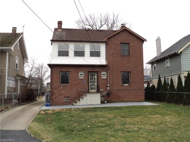 Notice the second floor enclosed sunporch and maintenance free brick exterior.
