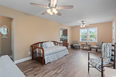Bedroom with dark hardwood / wood-style flooring a
