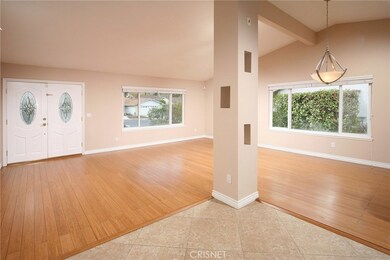 The stunning white paneled front doors with etched glass inserts sweep open to a bright and flowing open concept floor plan with many captivating architectural elements. The formal living room is bathed in natural light from a multitude of windows an