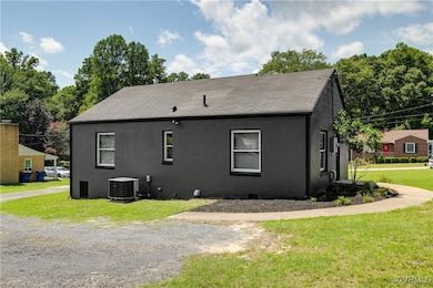 View of side of home with roof with shingles and a