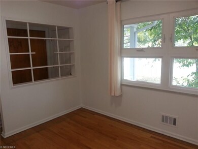 Dining room area offers plenty of light and hardwo