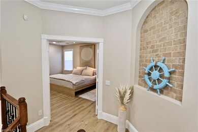 Stairway with a chandelier and hardwood / wood-style flooring