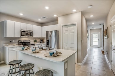 Kitchen with a breakfast bar area, light tile patt